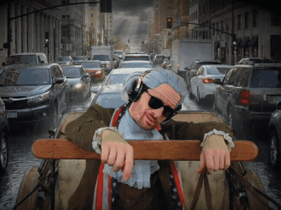 Man In Headphones And Sunglasses Leaning Over Railing In Car GIF
