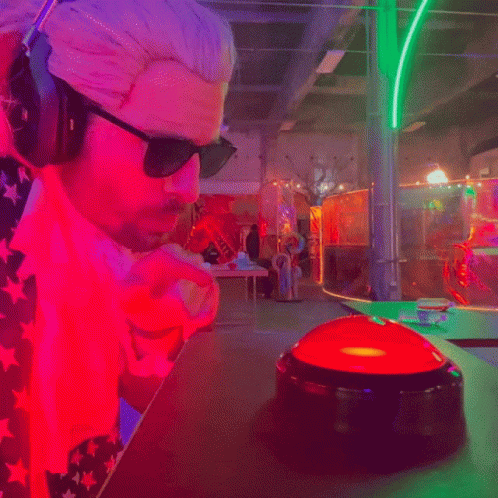 Man In Headphones And Sunglasses Looking At Red Button GIF
