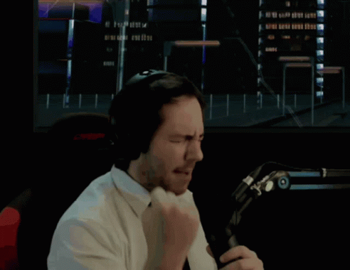 Man In Headphones And Tie Holding Fist Up GIF