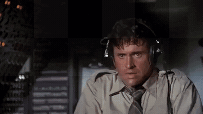 Man In Headphones And Tie In Airplane Cockpit GIF