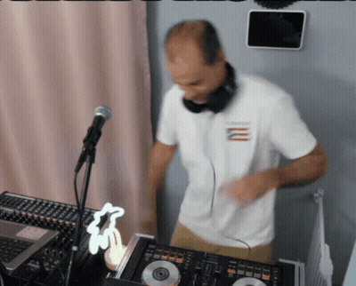 Man in Headphones and White Shirt With Letter M Playing Music