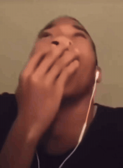 Man In Headphones Covering Mouth GIF