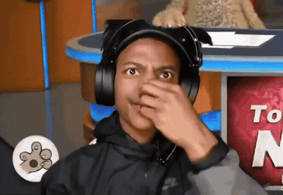 Man In Headphones Covering Nose In Front Of Sign Saying To GIF