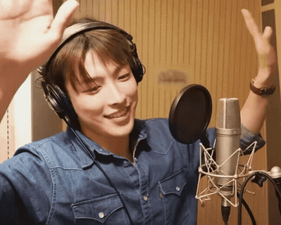 Man In Headphones Hand Up At Microphone GIF