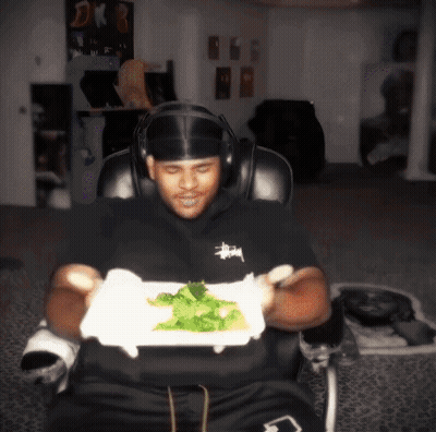 Man In Headphones Holding Plate Of Food GIF