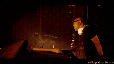 Man In Headphones In Front Of Fire Show GIF