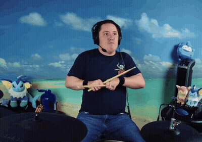 Man In Headphones Playing Drums With Stuffed Animals GIF