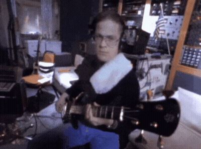 Man In Headphones Playing Guitar At Microphone GIF