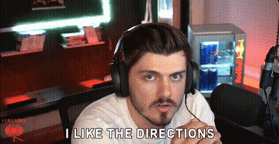 Man In Headphones Saying I Like The Directions In Front Of Red Bull Cooler GIF