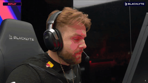Man In Headphones Sits In Blacklyte Gaming Chair GIF
