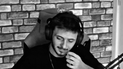 Man In Headphones Sitting In Chair In Front Of Brick Wall GIF