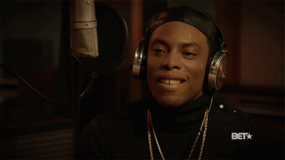 Man In Headphones Smiling At Microphone With BET Logo GIF