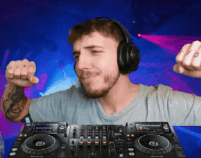 Man in Headphones Standing at DJ Mixer