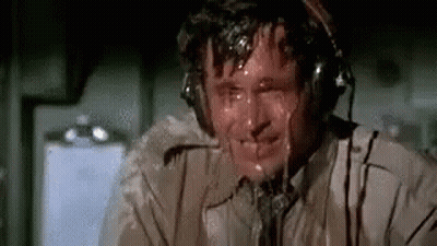Man In Headphones Sweating In Airplane GIF