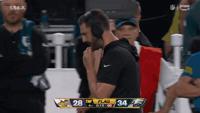 Man In Headphones Watching Vikings Vs Eagles Scoreboard GIF