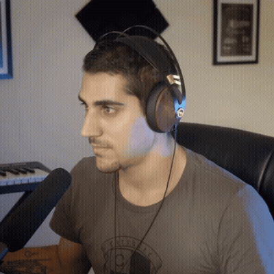 Man In Headphones Wearing Eclectic T-Shirt GIF