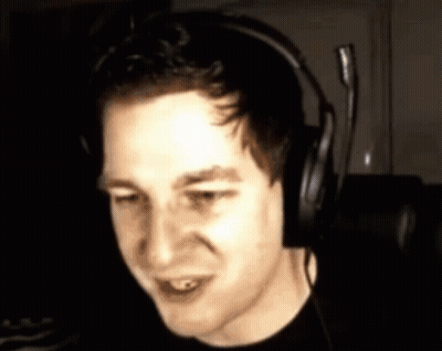 Man In Headphones With Microphone Looking At Camera GIF