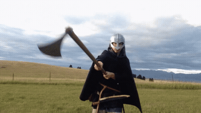 Man In Helmet And Cape Holding Axe GIF