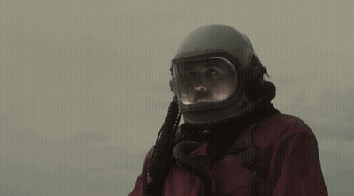 Man In Helmet And Gloves Waving GIF