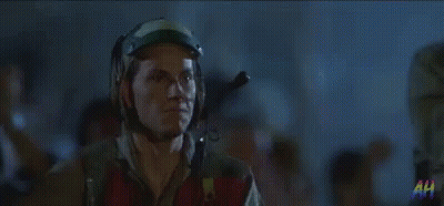 Man In Helmet And Goggles Standing In Crowd GIF