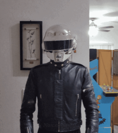 Man In Helmet And Leather Jacket At Arcade Game GIF