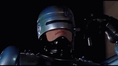 Man In Helmet And Mask Holding Gun Says We're Only Human GIF
