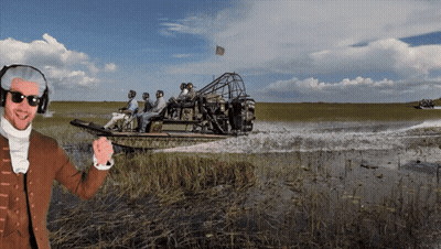 Man In Helmet And Sunglasses In Front Of Boat With People GIF