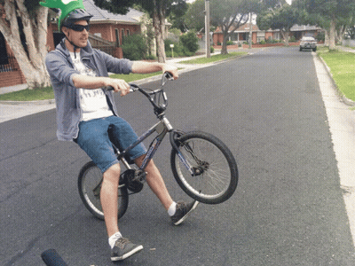 Man In Helmet And Sunglasses Riding Bicycle GIF