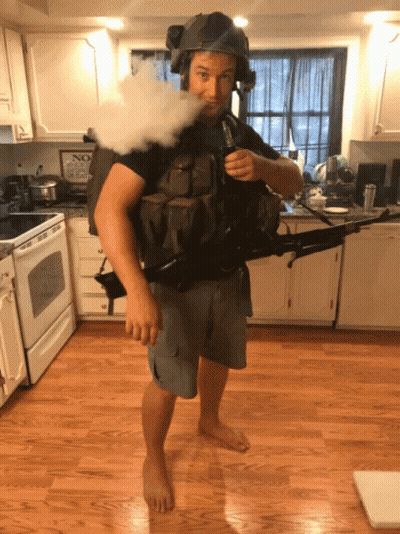 Man In Helmet Holding Gun Smoking Cigarette GIF