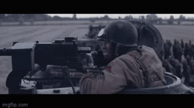 Man In Helmet Holding Machine Gun In Tank GIF