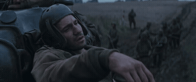 Man In Helmet Lying In Field With Soldiers GIF