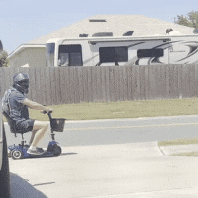 Man In Helmet Riding Mobility Scooter GIF
