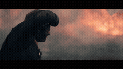 Man In Helmet Standing Before Fire GIF