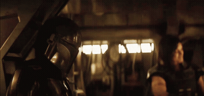 Man In Helmet Standing In Dark Room GIF
