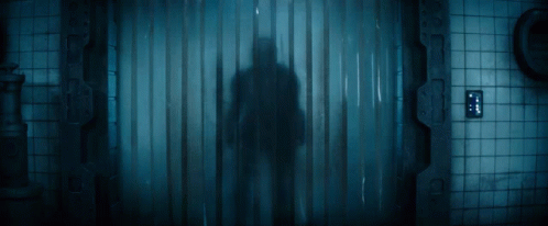 Man In Helmet Standing In Dark Room GIF