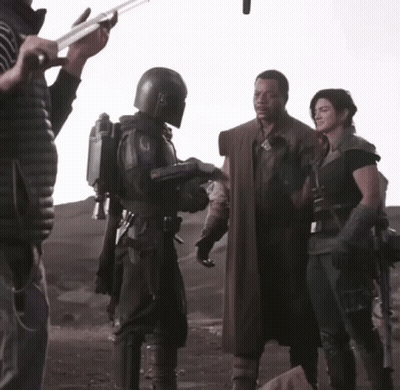 Man In Helmet Talking To Woman In Black GIF