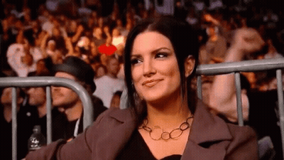Man In Helmet Talking To Woman In Black GIF