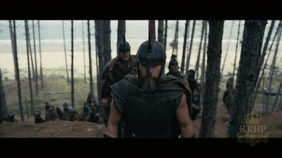 Man In Helmet Walking Through Forest With Others GIF