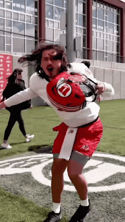 Man In Helmet With Letter U Dancing On Field GIF