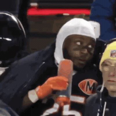 Man In Helmet With M Holding Hot Dog GIF