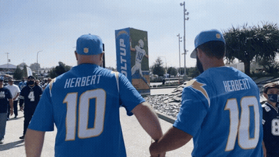 Man In Herbert Jersey Holding Hands With Another Man GIF