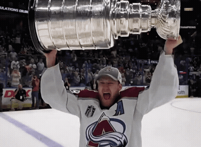 Man In Hockey Jersey Holding Trophy GIF