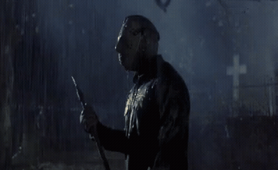 Man In Hockey Mask Holding Spear In Cemetery GIF