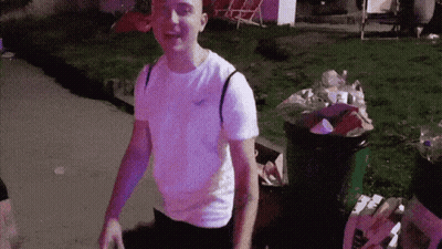 Man In Hollister T-Shirt By Trash Can GIF