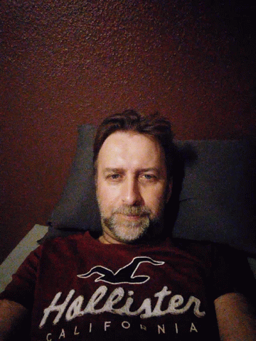 Man In Hollister T-Shirt Lying Down GIF
