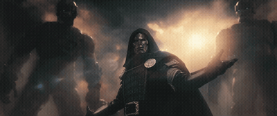 Man In Hooded Cloak Stands In Front Of Monsters GIF