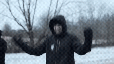 Man In Hooded Jacket And Mittens Standing In Snow GIF