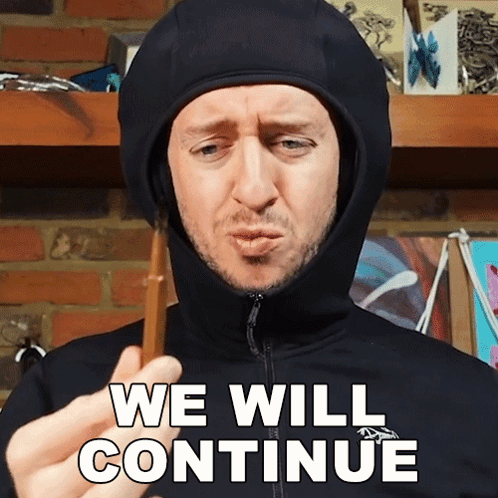 Man In Hooded Jacket Holding Stick We Will Continue GIF