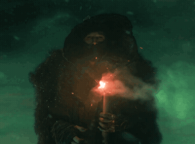 Man In Hooded Jacket Holding Torch GIF