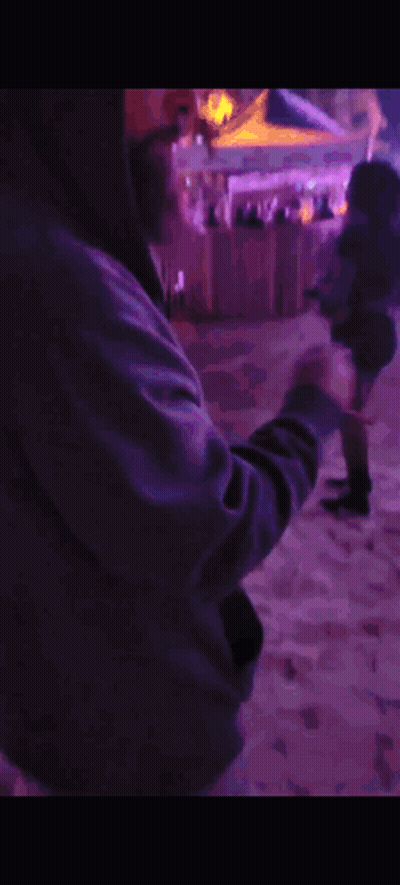 Man In Hooded Jacket In Front Of Purple Lights GIF